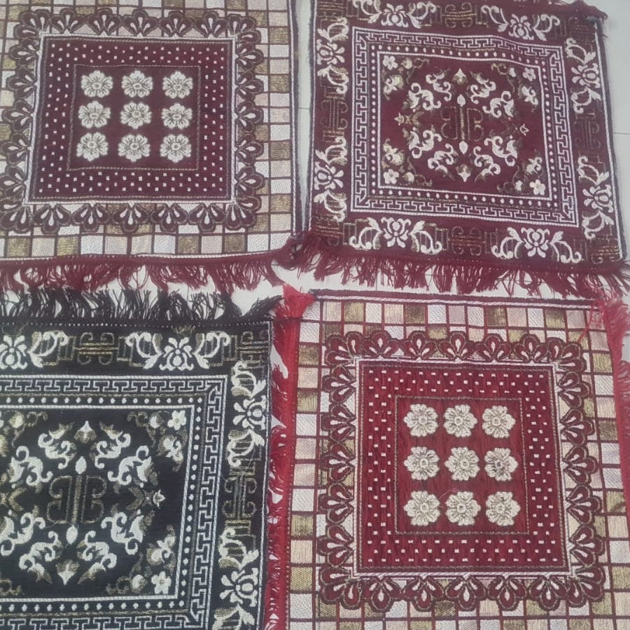 Set of patterned fabric squares with intricate designs on a checkered background