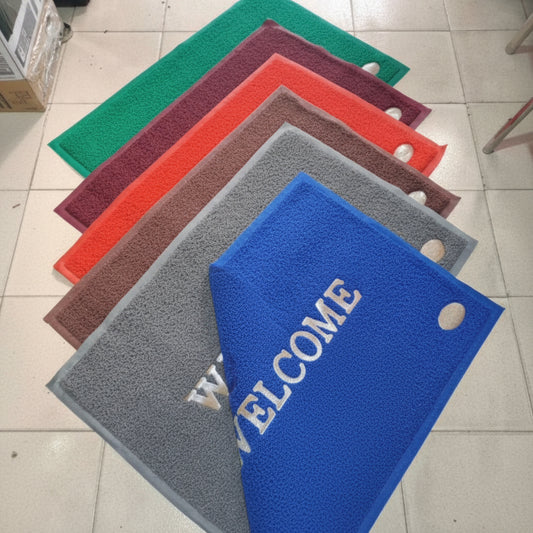 Set of colorful mats with visible branding on a tiled floor.