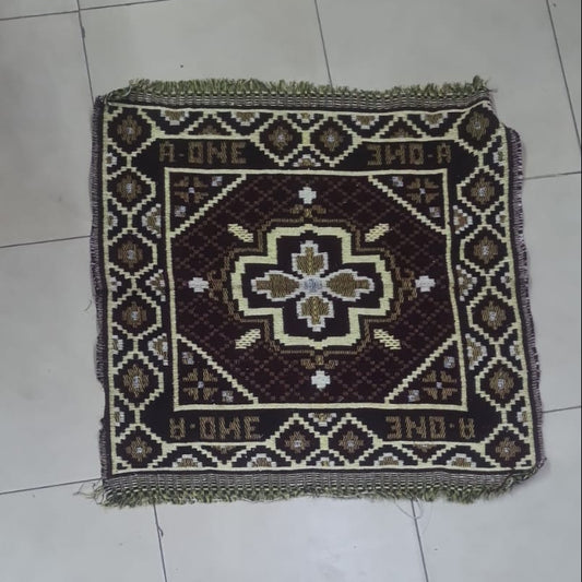 Decorative rug with a geometric pattern on a tiled floor.