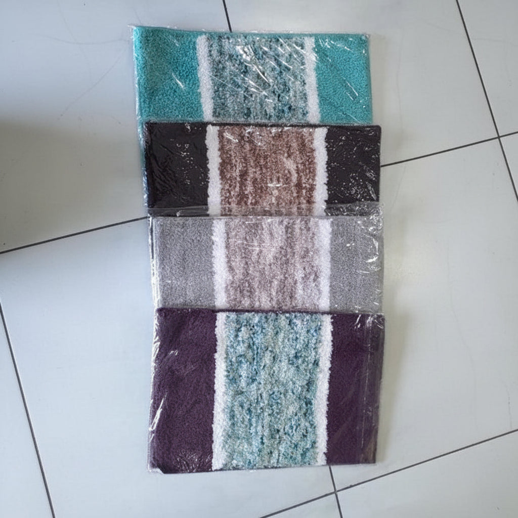 Set of striped bath mats on a tiled floor