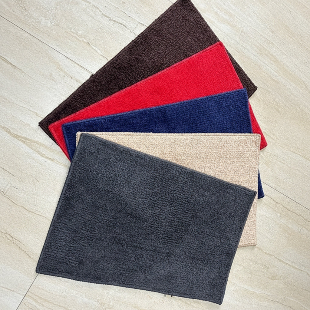 Four rectangular fabric samples in black, red, blue, and beige on a light wooden surface.