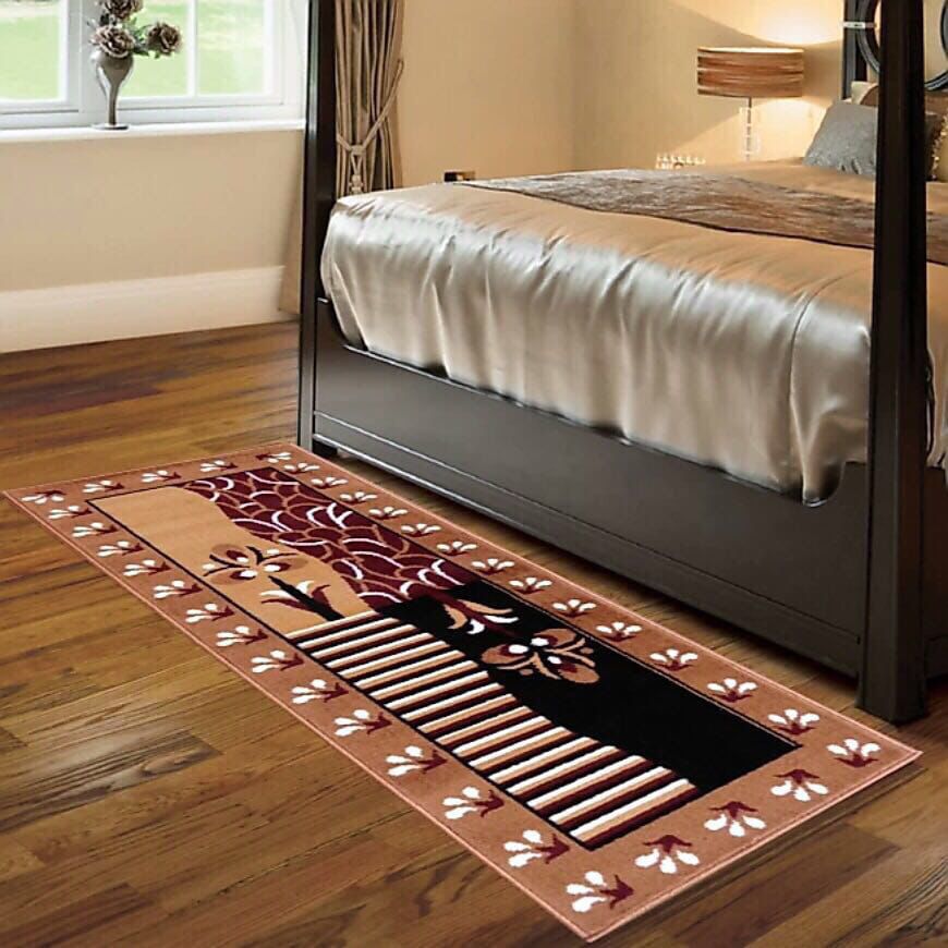Decorative rug with floral pattern on a wooden floor in a bedroom.