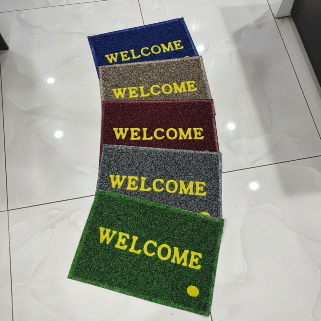 Four doormats with 'WELCOME' text in different colors on a tiled floor.