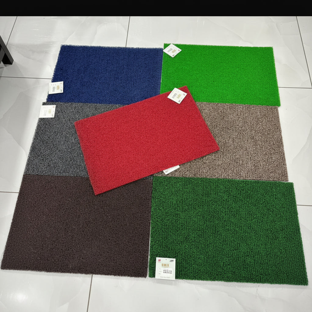 Color swatches of different colored mats on a tiled floor.