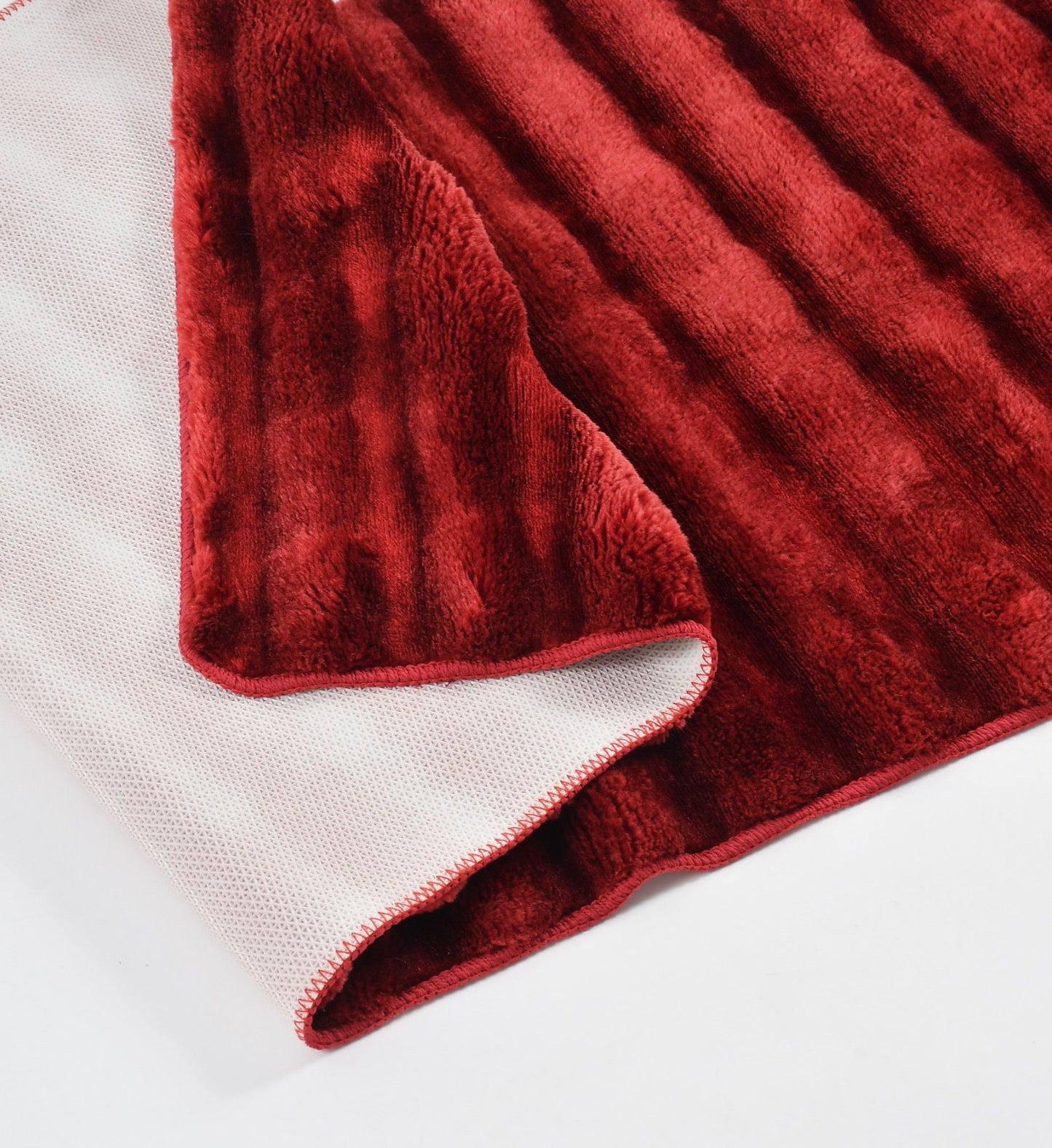 Red textured blanket on a white background
