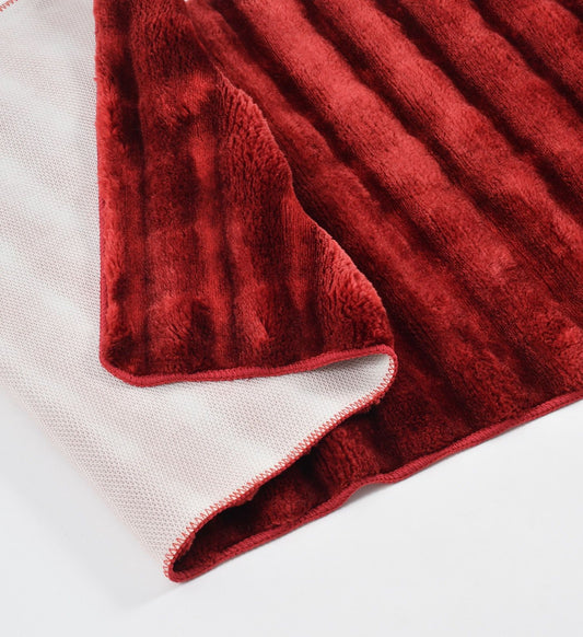Red textured blanket on a white background