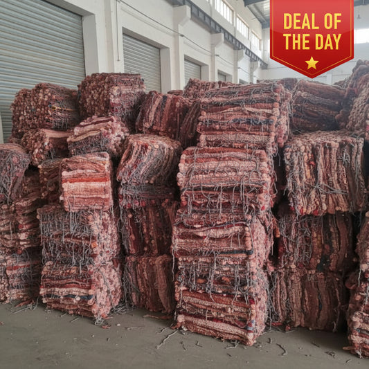 Stack of textured rugs with a mix of colors and patterns.