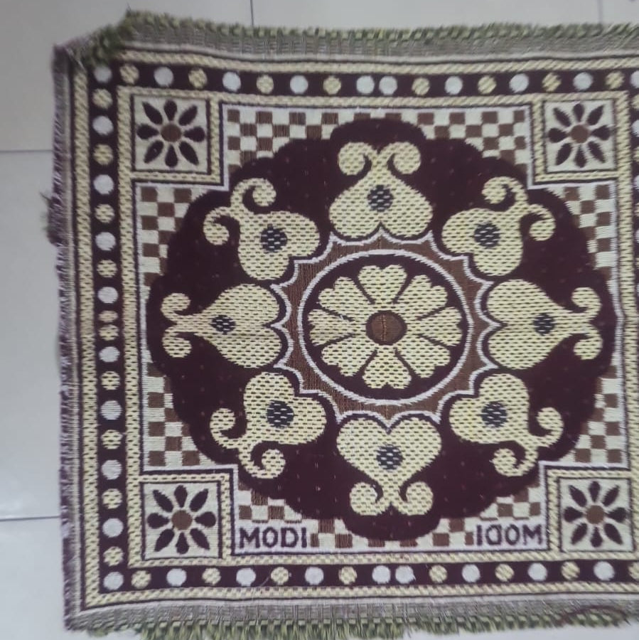 Decorative mat with intricate patterns on a tiled floor
