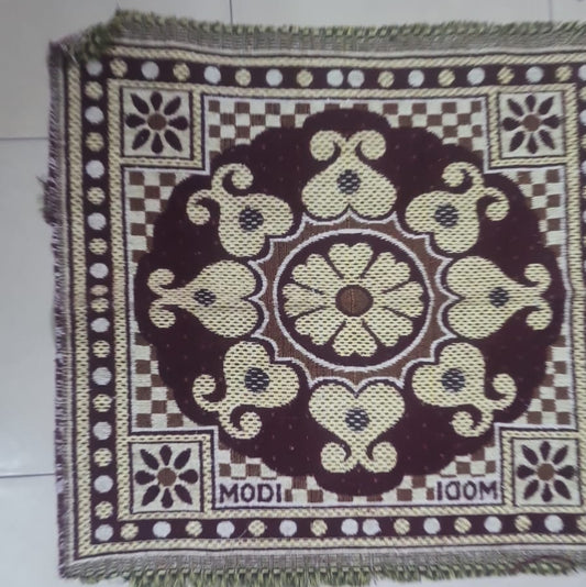 Decorative mat with intricate patterns on a tiled floor