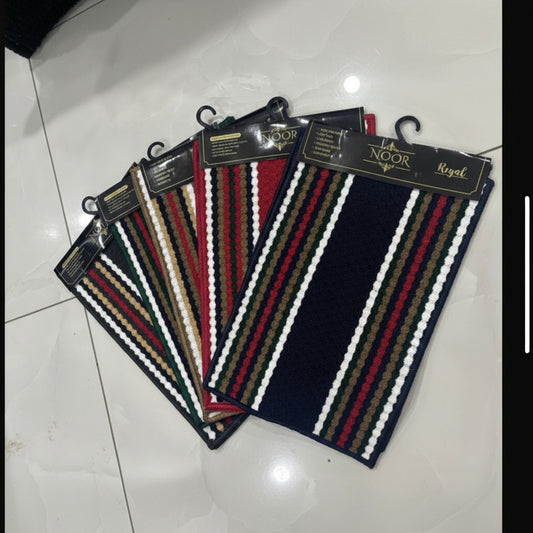 Striped belt with a brand tag on a tiled floor