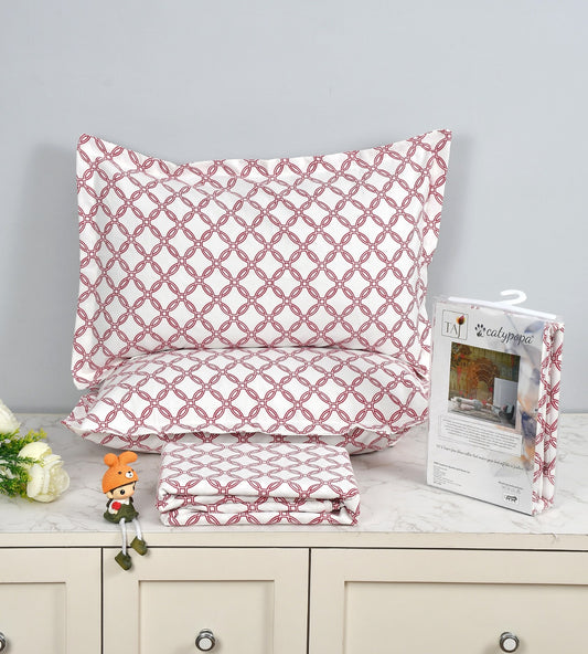 Red and white patterned pillowcases on a wooden surface with packaging and decorative items.