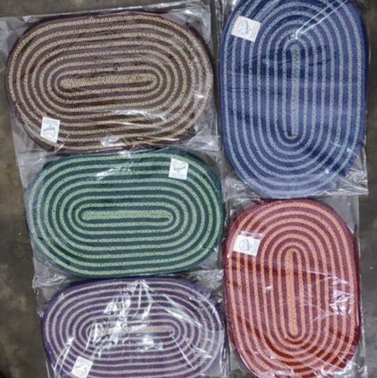 Set of six oval mats in different colors packaging on a dark surface
