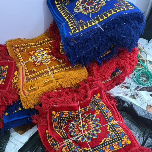 Colorful embroidered cushions with intricate patterns on a white background