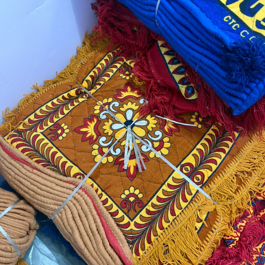 Colorful embroidered fabric with intricate patterns on a plain background