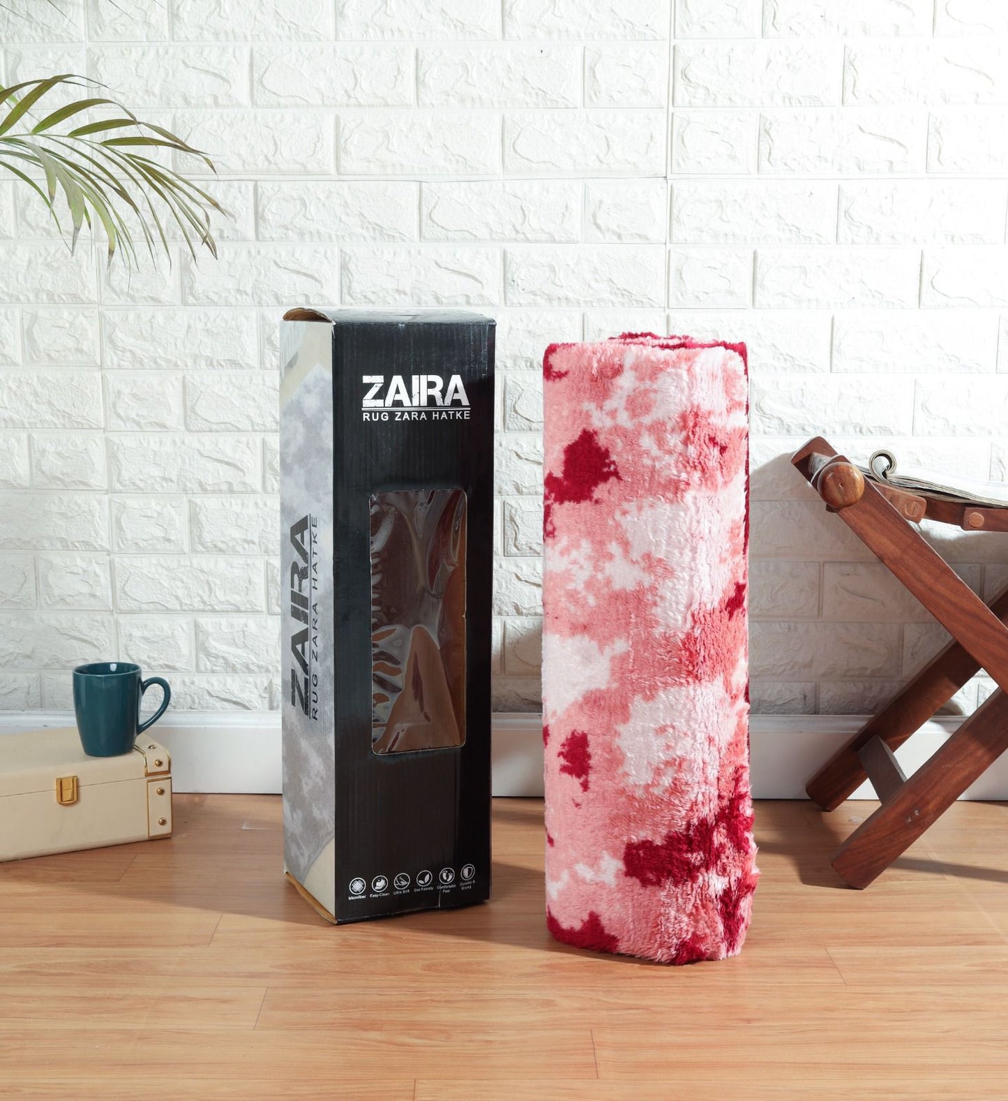 Zaira brand packaging with a pink and white patterned product on a wooden floor.