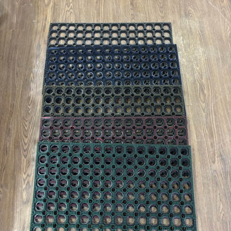 Black and green textured mat on a wooden floor